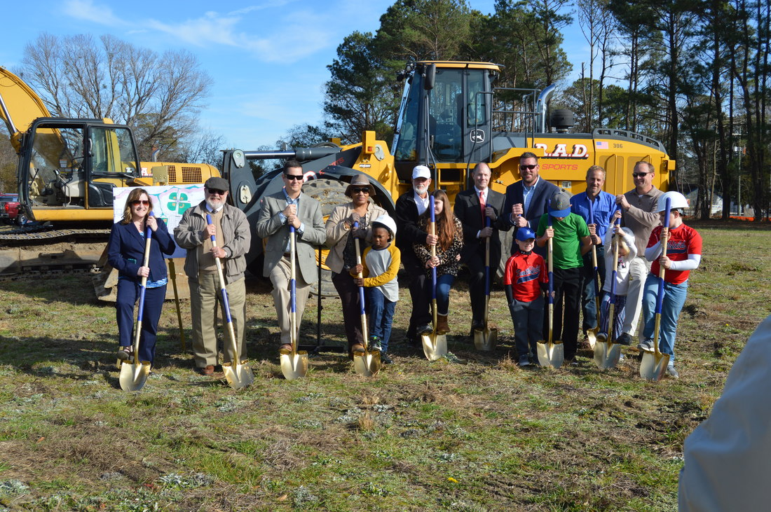 Group Posing with Shovels for Digging Ground Breaking